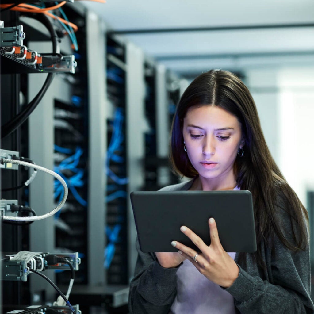 A person using a tablet in a data center.