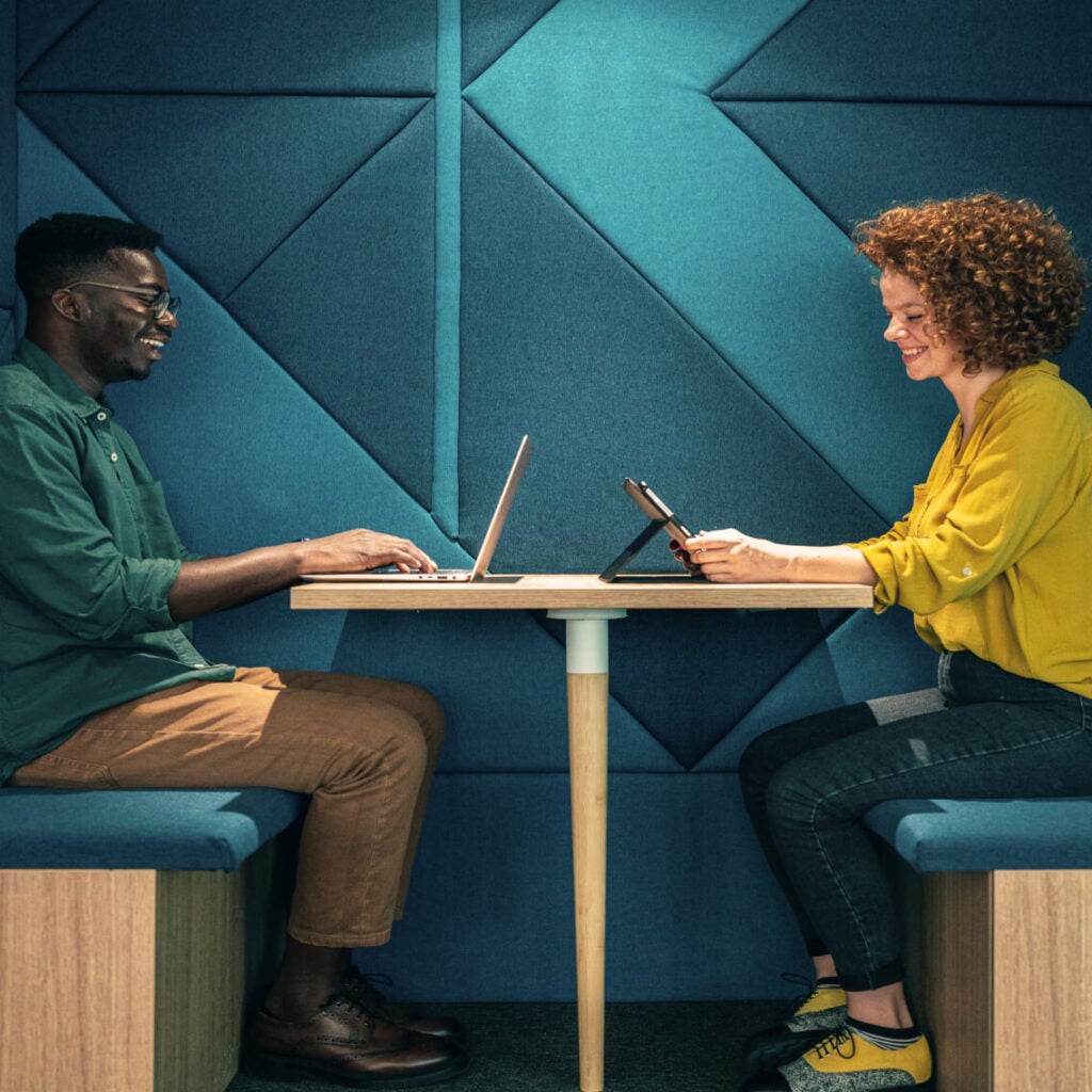 Two people working in a booth.