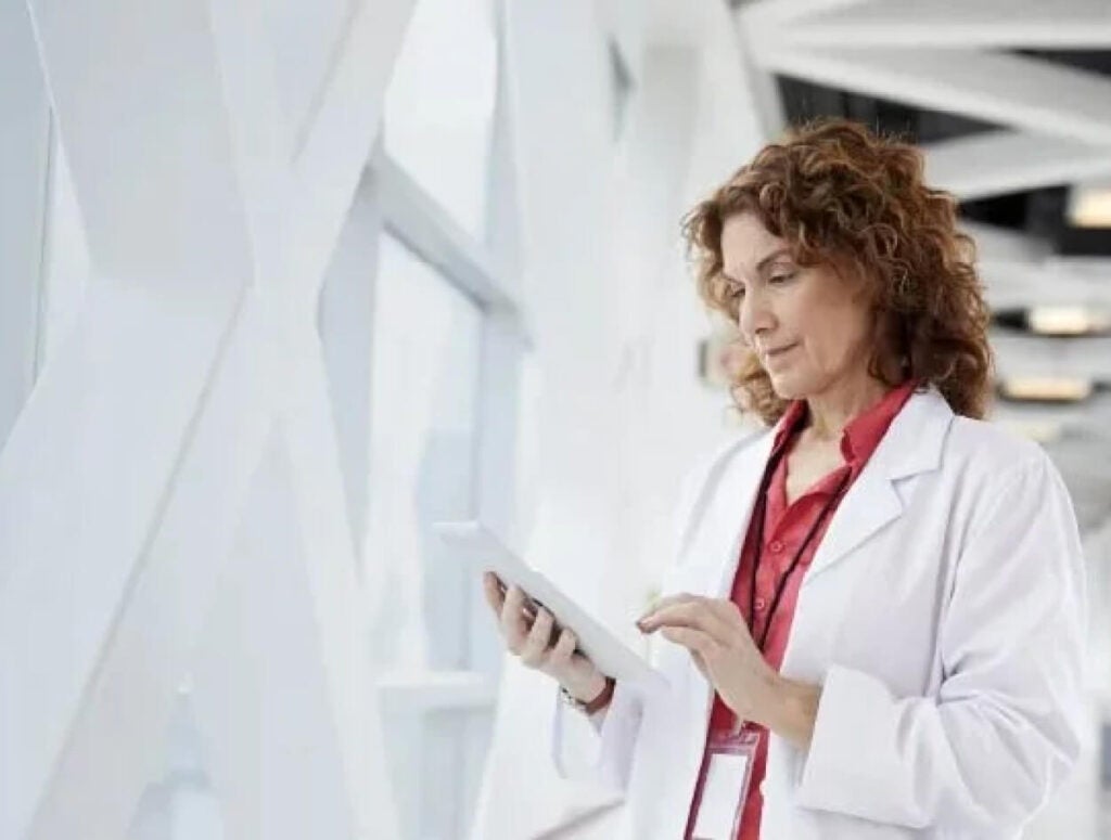 A doctor working off a tablet.