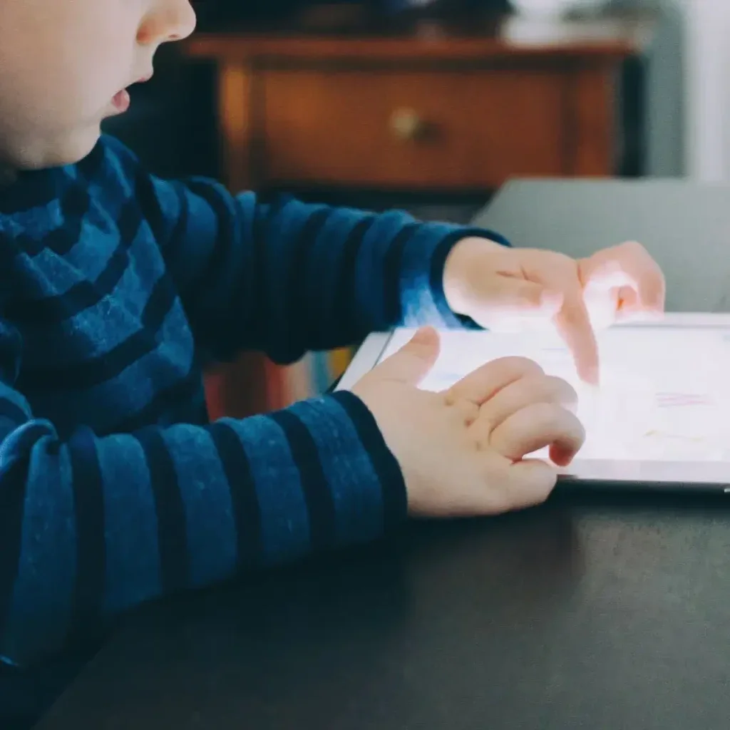 Child accessing assignment through a tablet.